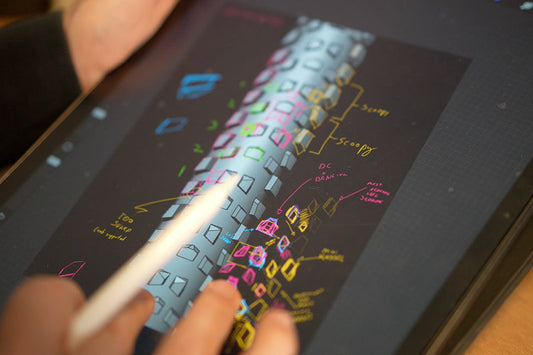 Engineer drawing of tread design on tablet with person making notes