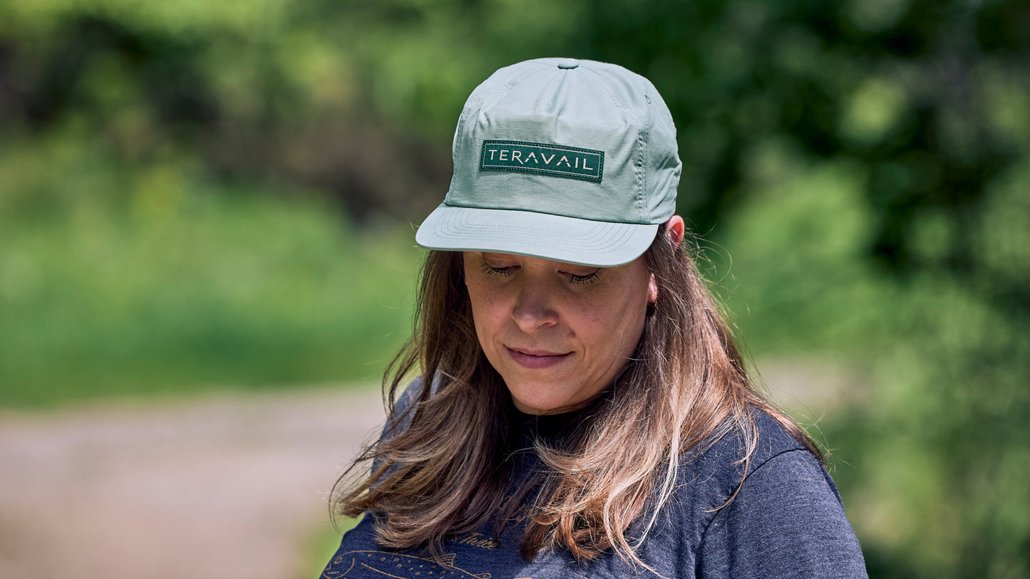 Person wearing a cap with 'Teravail' logo outdoors