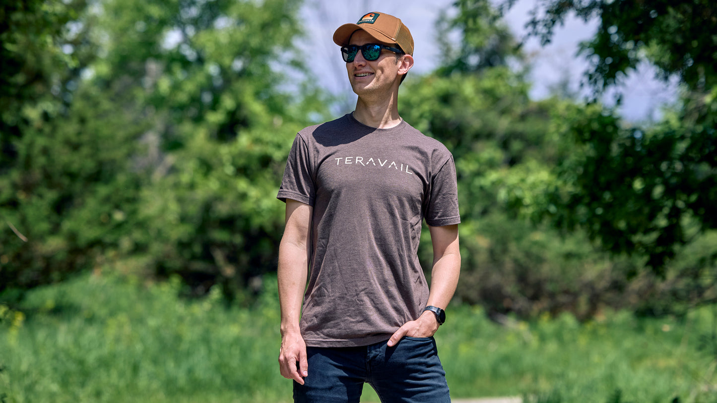 Person wearing Teravail logo t-shirt outdoors in sun