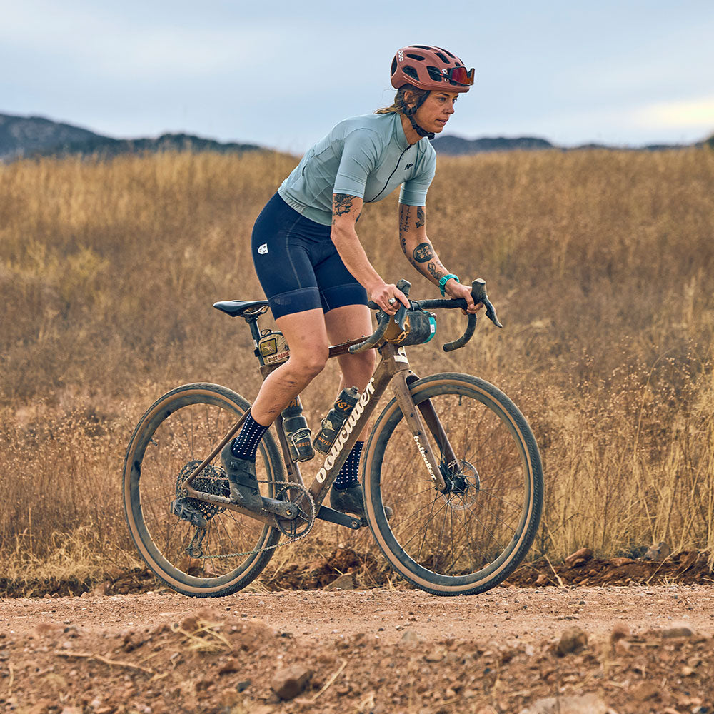 Cyclist out of saddle on gravel road