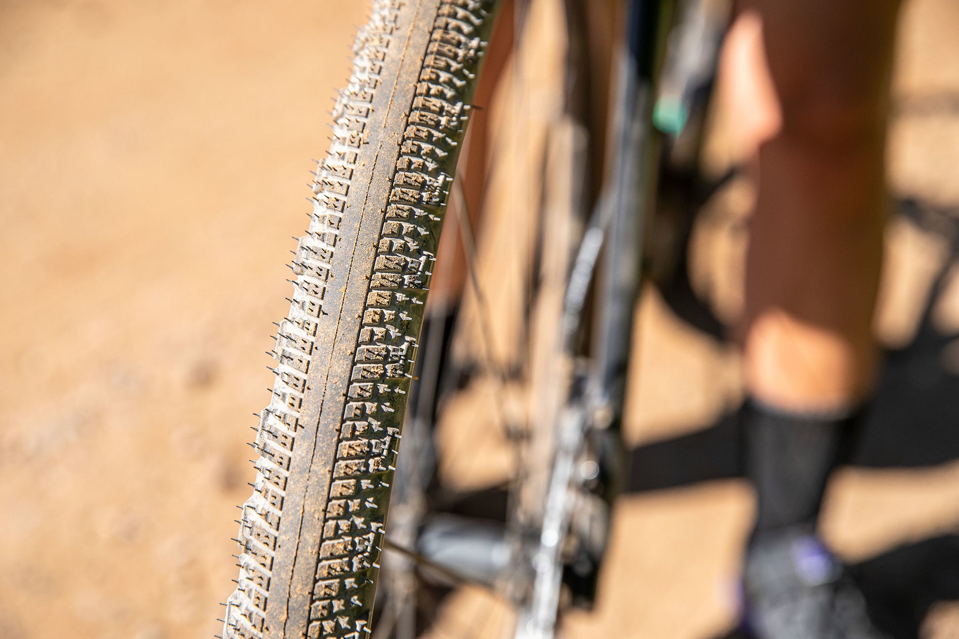 Close-up of a bicycle tire with tread pattern on a blurred background