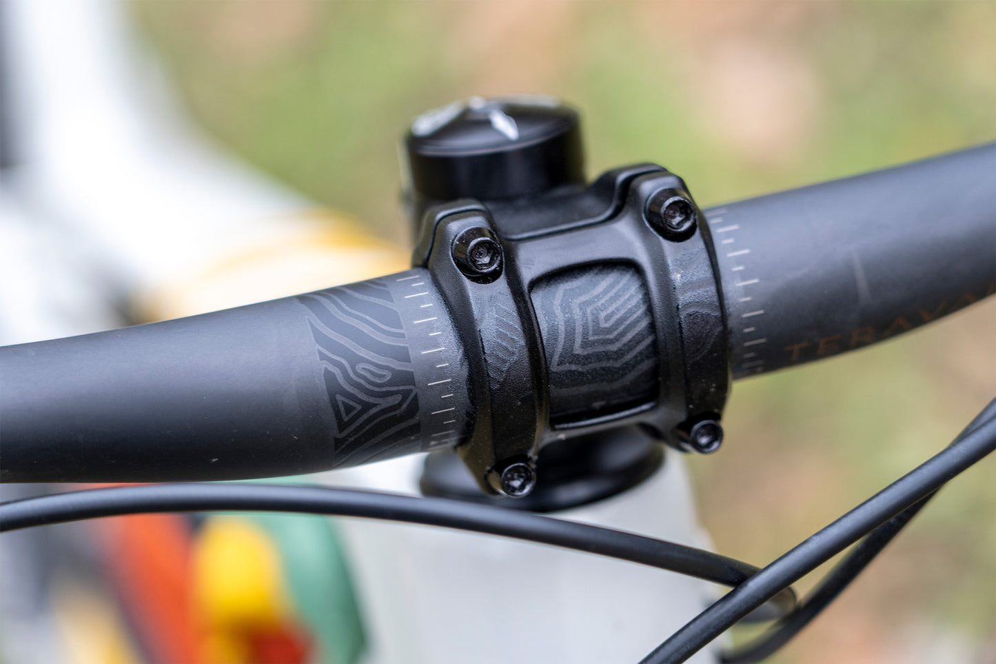 Close-up of a bicycle handlebar and stem with a blurred background