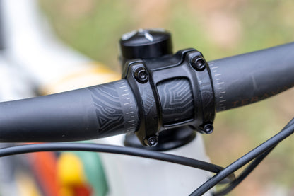 Close-up of a bicycle handlebar and stem with a blurred background