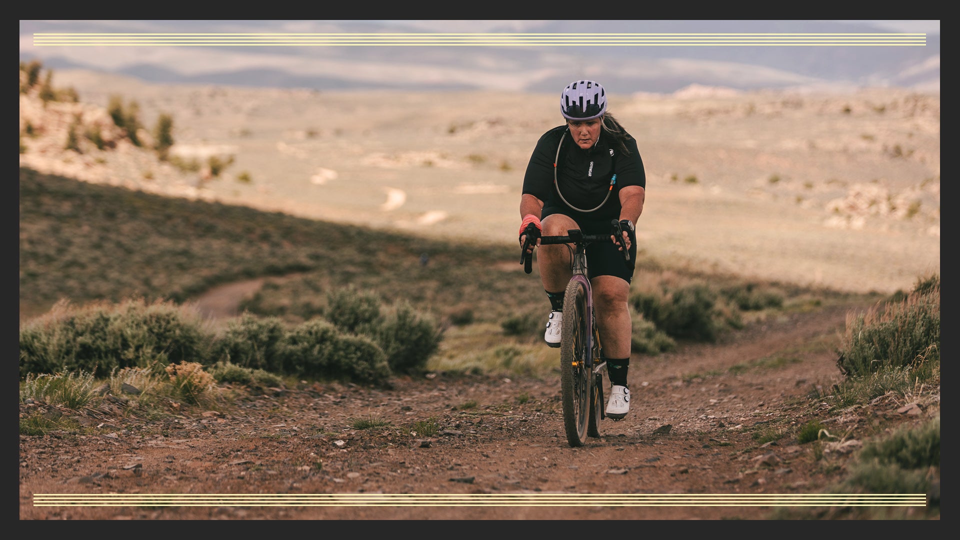 Cyclist riding rocky gravel road in high elevation desert