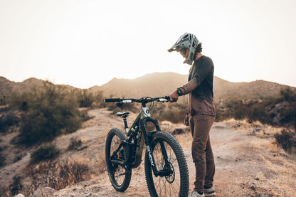 Person with a mountain bike in a desert setting