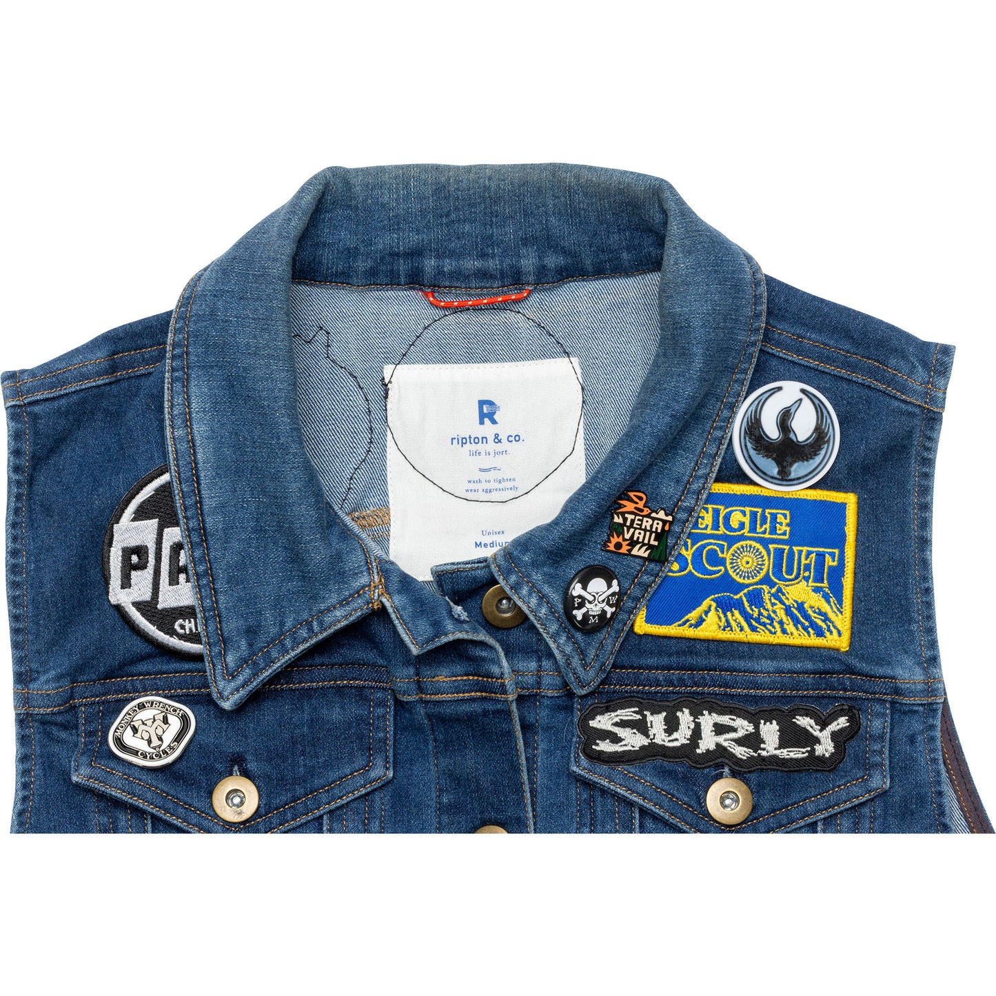 Blue denim jacket with various patches on a white background