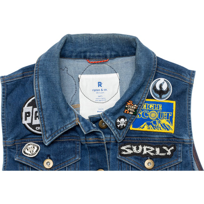 Blue denim jacket with various patches on a white background