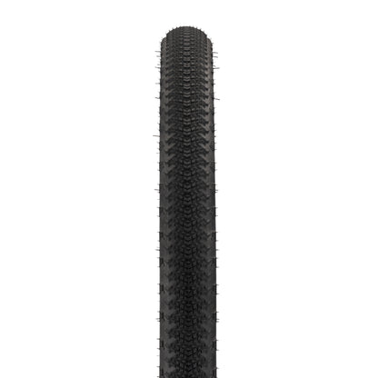 Black tire with tread pattern on a white background