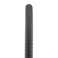 A black Cannonball tire designed for gravel riding with a distinctive tread pattern.