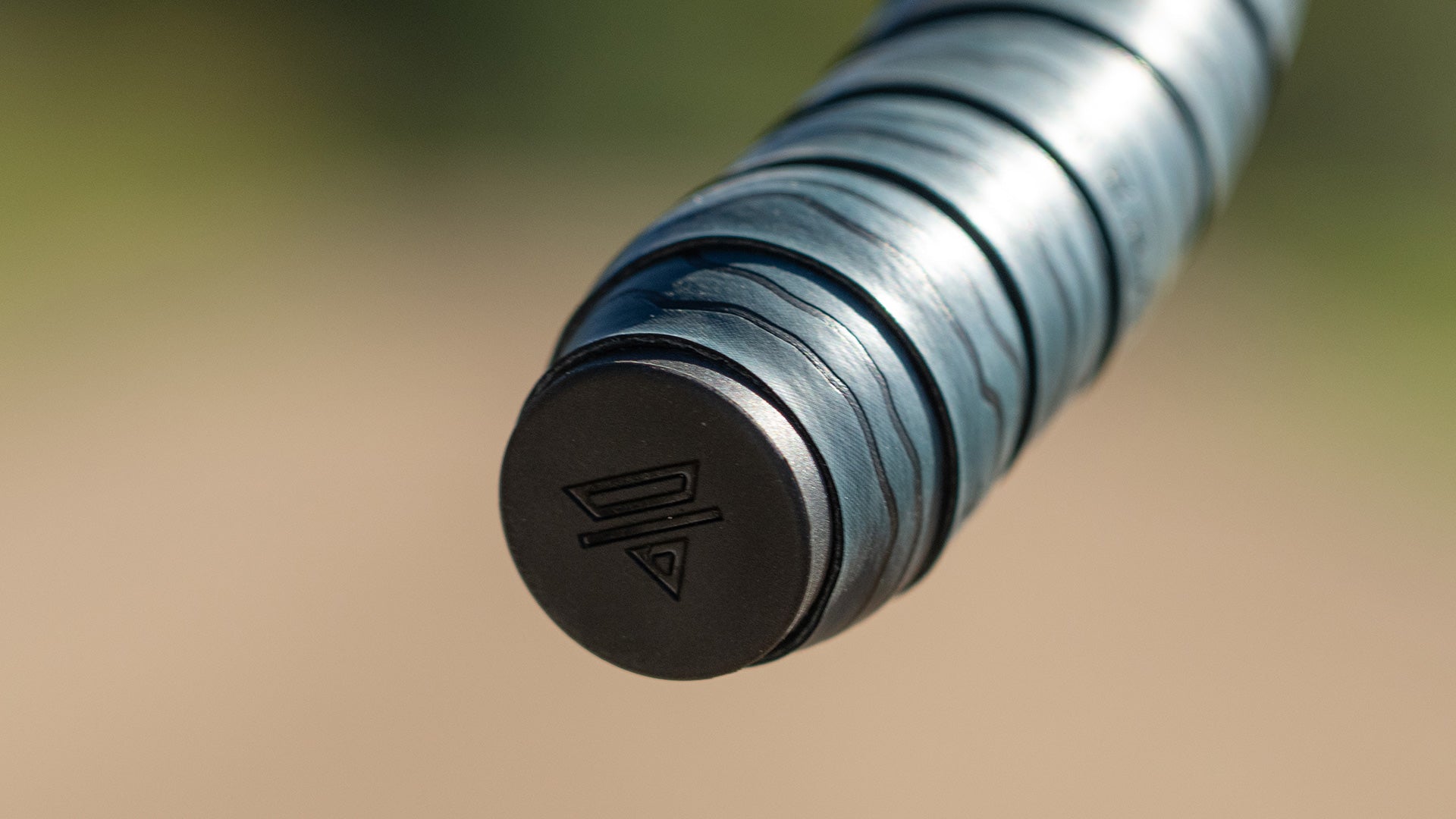 Close-up of a rubber bar end plug on wrapped drop bar on a blurred background