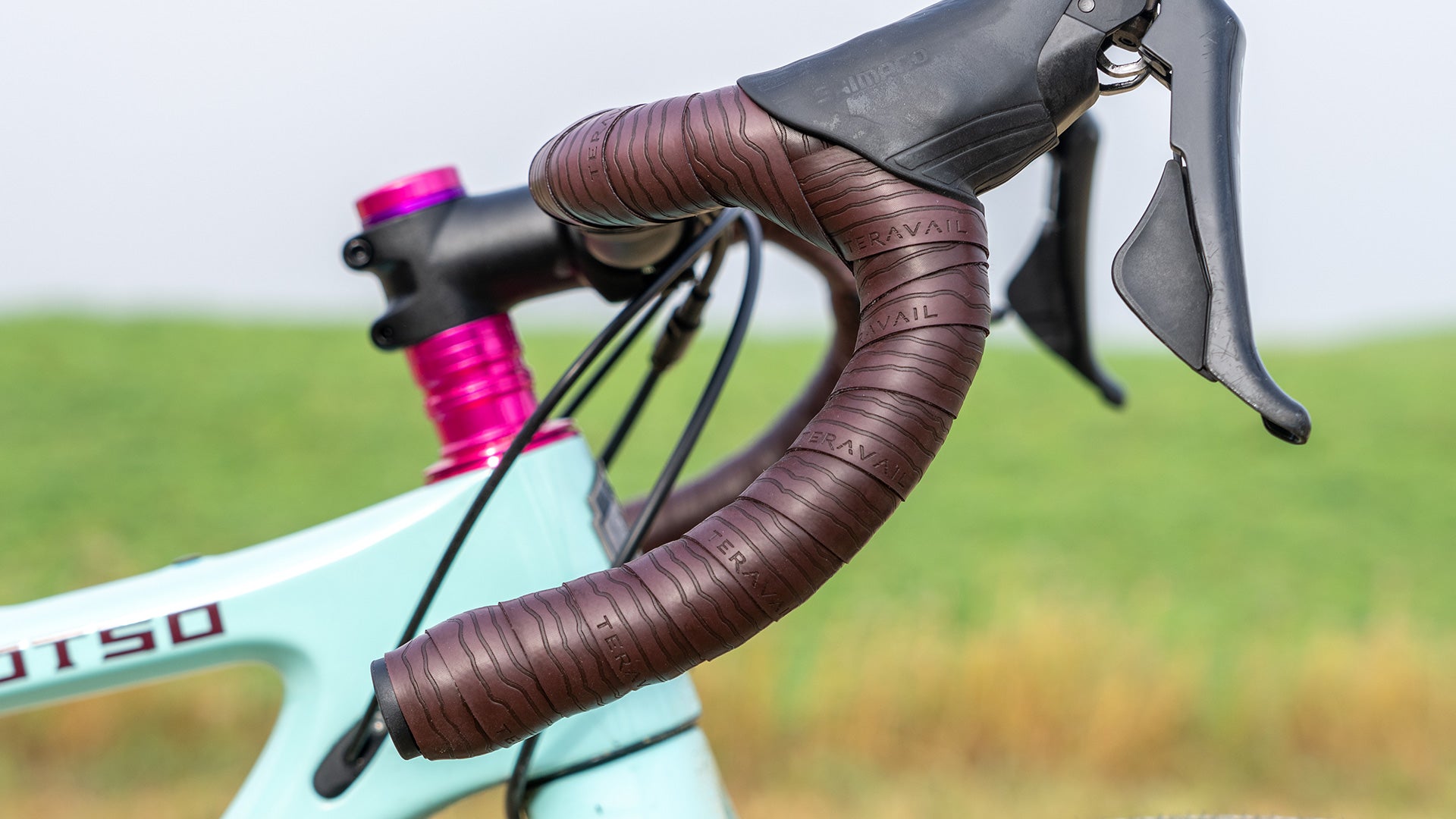 Close-up of bike drop bar with Teravail tape outside with blurred natural background