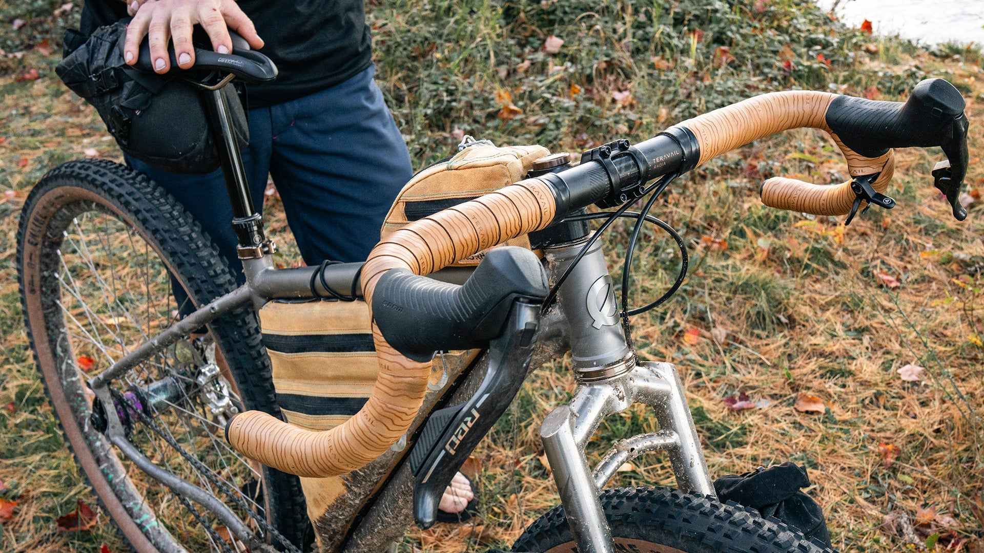Person holding bicycle focus on handlebar and stem
