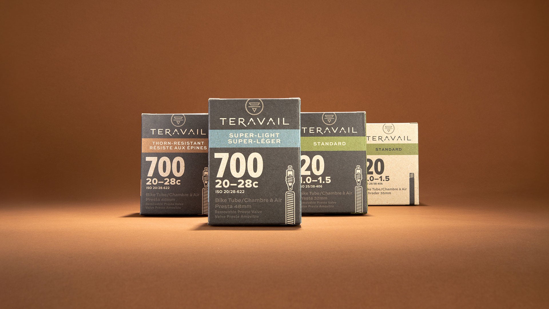 Teravail bicycle inner tube different sizes together in packaging on copper background