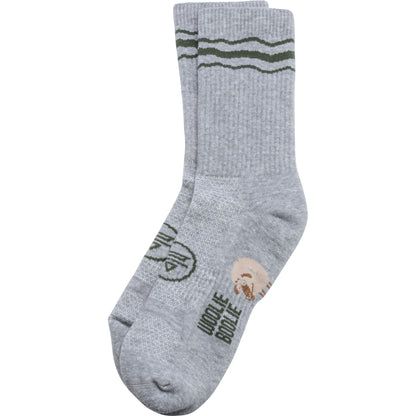 A pair of heather gray crew socks with olive green stripes near the cuff and a circular logo with the text 'WOOLIE BOOLIE' on the sole, shown against a plain white background.